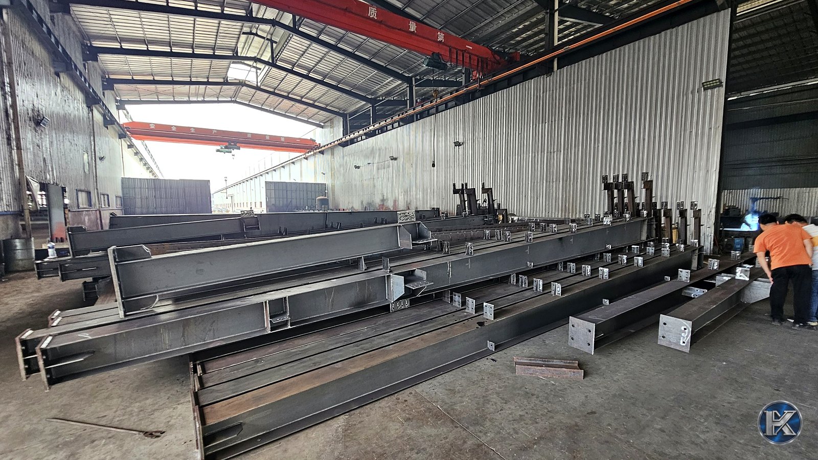 Fabricated steel columns and beams prepared inside a structural steel factory